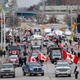WINDSOR, ON - February 10: Protestors and supporters set up at a blockade at the foot of the Ambassador Bridge, sealing off the flow of commercial traffic over the bridge into Canada from Detroit, on February 10, 2022 in Windsor, Canada. As a convoy of truckers and supporters continues to occupy Ottawas downtown, blockades and convoys have popped up around the country in support of the protest against Canada’s COVID-19 vaccine mandate for cross-border truckers.